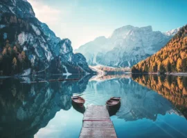 Boats on the Braies Lake ( Pragser Wildsee ) in Dolomites mountains, Sudtirol, Italy