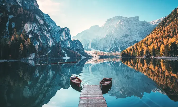 Boats on the Braies Lake ( Pragser Wildsee ) in Dolomites mountains, Sudtirol, Italy