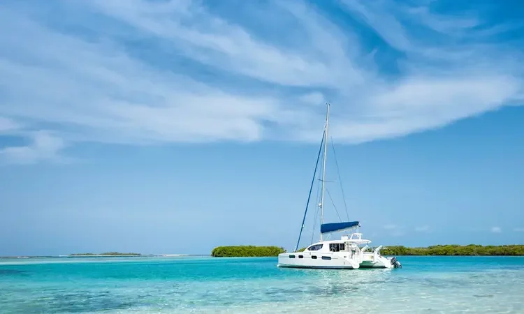 Catamaran anchored near de beach at Los Roques Archipelago Venezuela on a sunny day in a beautiful island